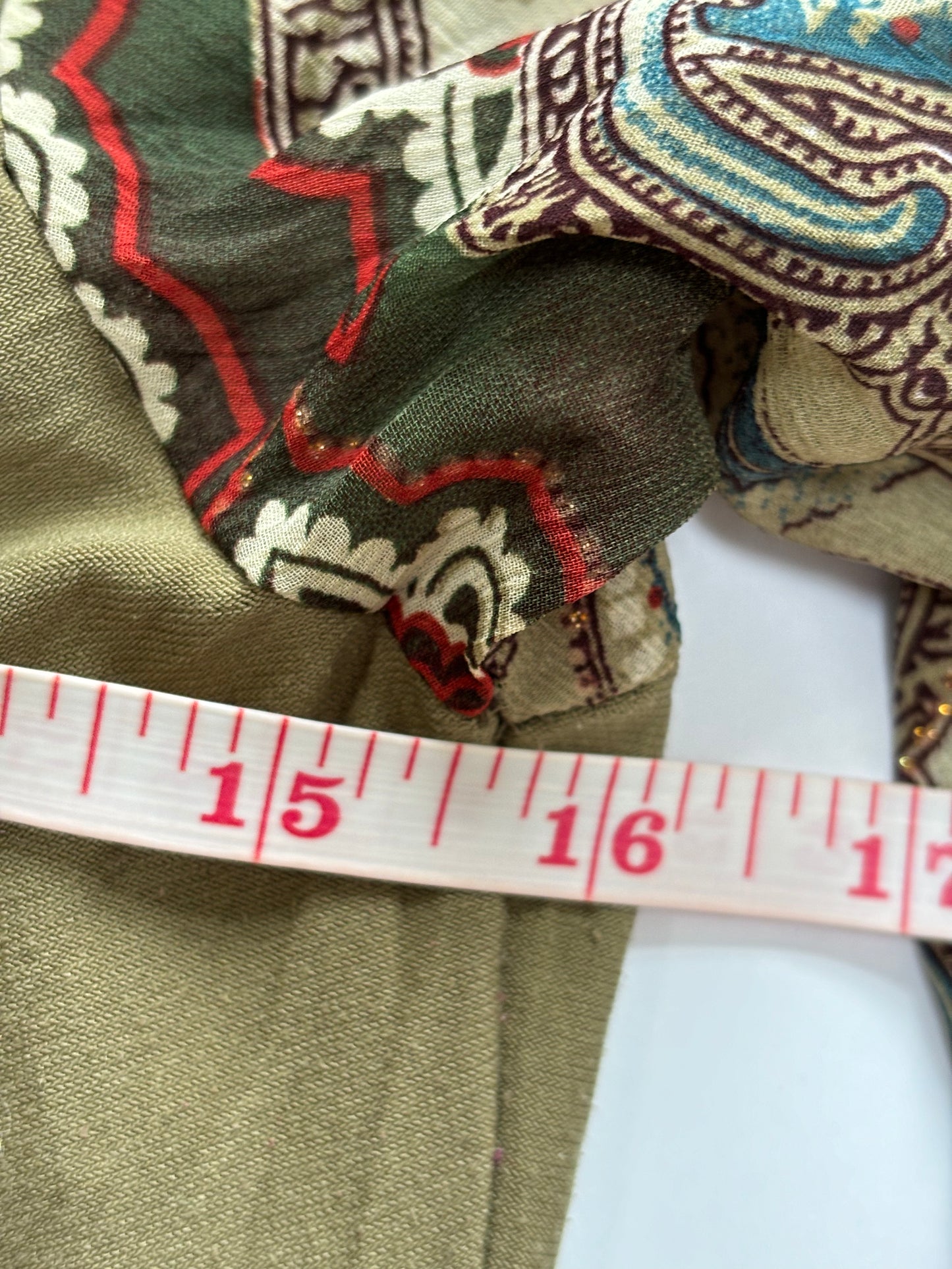 green long sleeve top with coin details